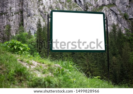 Outdoor billboard blank for advertising poster with mockup in forest.