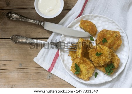 A traditional American dish of fried green tomatoes served with yogurt. Rustic style.