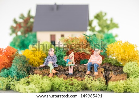 Miniature young parent with their daughter in the garden  