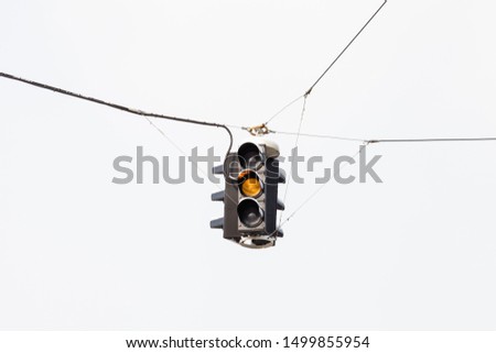 Amber Traffic Light.  A snow covered suspended amber traffic light is pictured in mid winter in Salzburg, Austria.