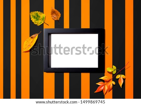 Autumn leaves with blank photo frame - overhead view flat lay