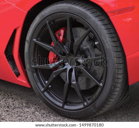 A spider spoke like black rim on a low profile, Ultra High Performance tire. Royalty-Free Stock Photo #1499870180
