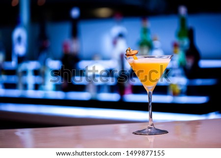 Beautiful orange cocktail on the bar counter.