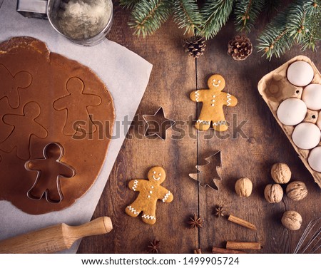 Christmas background. Christmas preparation, kitchen table with dought for cooking gingerbread man