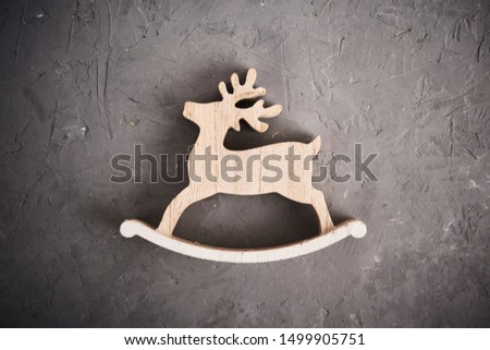 Christmas background. Cristmas decoration toy wooden deer over concrete background. Christmas preparation concept