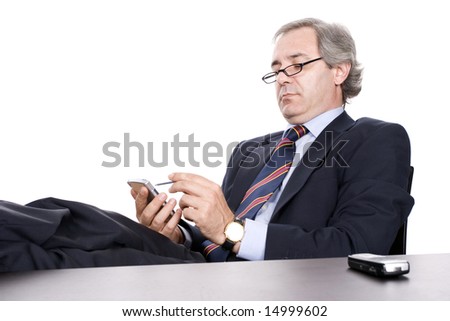 Mature Businessman working with PDA, isolated in white