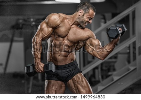 Hard Core Bodybuilding. Handsome Bodybuilder Workout at the Gym Royalty-Free Stock Photo #1499964830