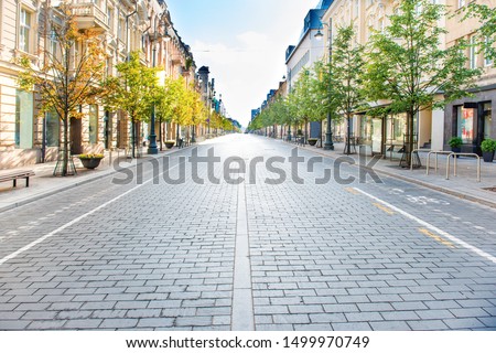 City street with empty road and morning light in Europe, Lithuania, Vilnius Royalty-Free Stock Photo #1499970749