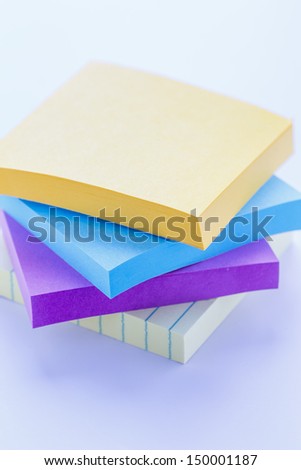Stack of colorful sticky note pads on white