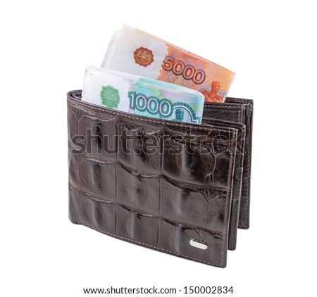 The brown  leather wallet with rubles is photographed on the close-up