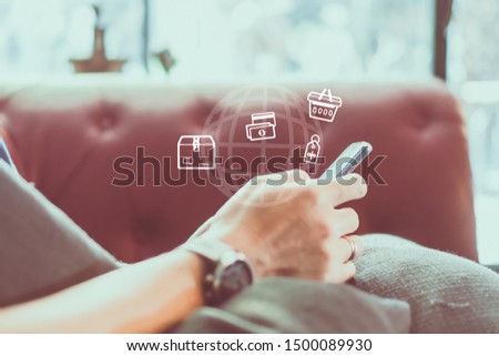 Women hand using smartphone do online selling for people shopping online in black friday with chat box, cart, dollar icons pop up in cafe shop background. Social media maketing concept.