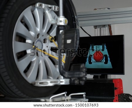 Focus on computer display 
that show a graphic of wheel balancer.
Car check up for a safety ride concept.