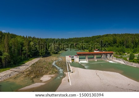 A sandbank in front of the isar river and a weir, shot by a drone.