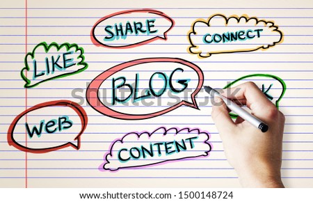 Blogging and social network concept with hand with pen writing words at notebook sheet background.
