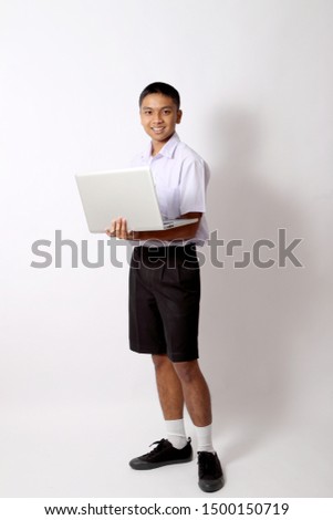 The young Thai student boy on the white background.