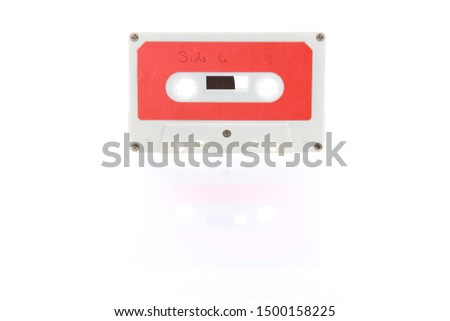 Audio cassette tape with reflection on a white background