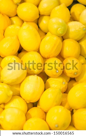Lot of bright yellow lemons in supermarket Royalty-Free Stock Photo #150016565
