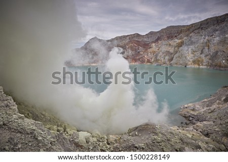 East Java, Indonesia, February 2016. Sulphur cloud in the lake of the  crater of the active volcano Kawah Ijen.