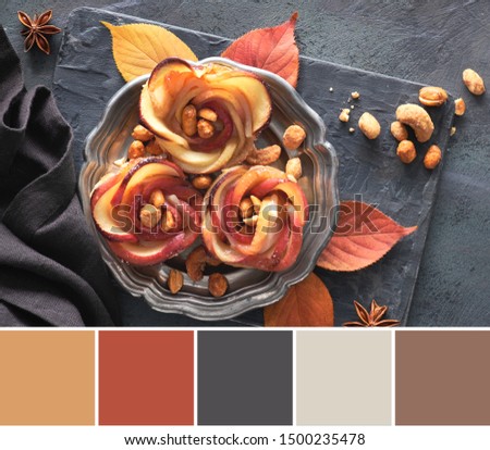 Color matching palette from picture of puff pastries with rose shaped apple slices on metal plate. Top lay on wooden board with Autumn leaves 