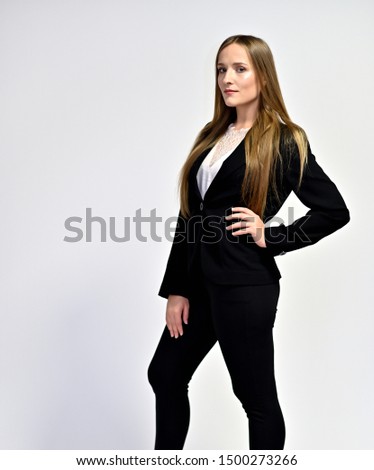 Business photo portrait of a young woman in a business suit on a light background. Well-groomed hair, slim figure. It is in different poses.