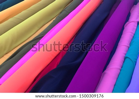 Colourful fabrics for sale at a textiles store.