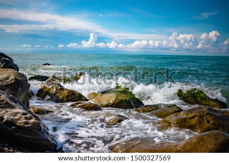 sea stones waves and blue sky