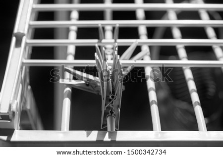 clothespins on an empty drying rack