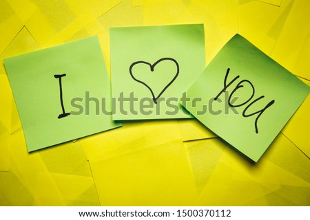 Three green sticky notes with word you I and heart symbol on yellow notes