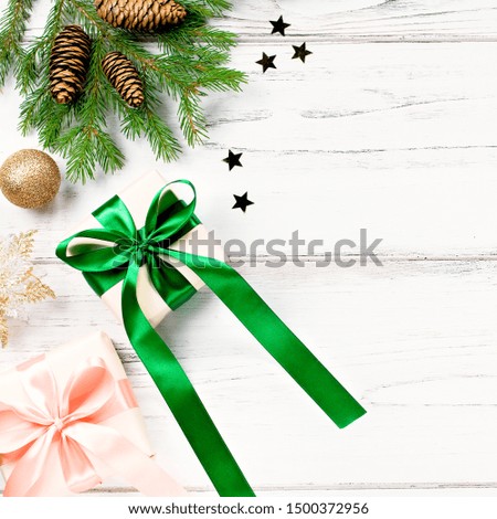 Christmas card with pink and emerald green elements, golden ornaments, confetti and wrapped gifts. Christmas flat lay