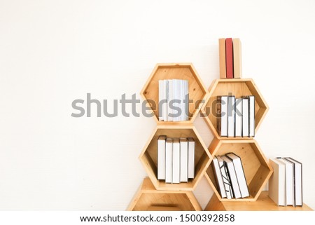 Many book put on wood bookshelf with white wall background copy space, learning or knowledge background concept