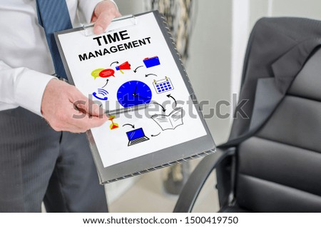 Businessman showing time management concept on a clipboard