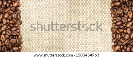 Roasted coffee beans right and left on a burlap background. Free space for text, menu