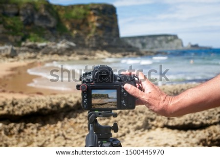 Taking pictures of a beach with the camera on the tripod