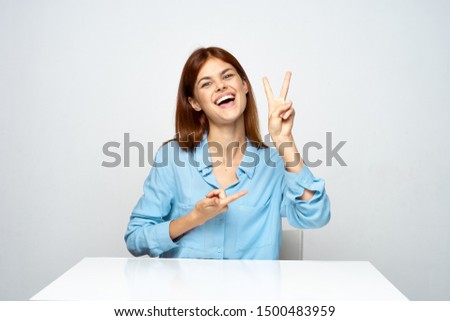 Blue shirt women office white table emotions gesticulate with hands                        