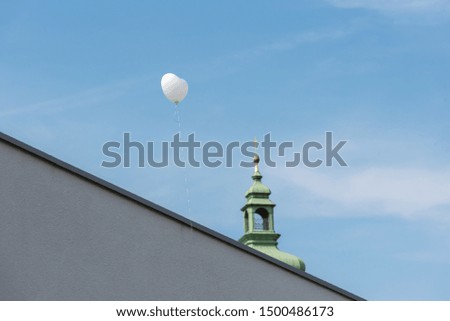 heart shaped balloon with cards in the sky