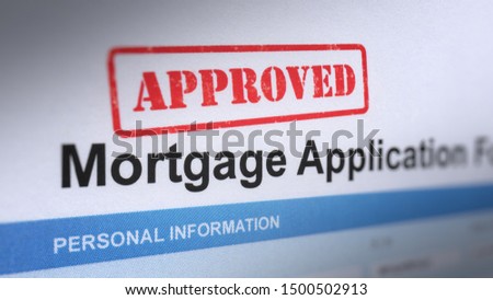 Close up shot of Mortgage Application Form With Red Approved Stamp.  Selective Focus and Blurry Image.

