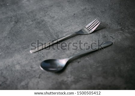 Forks and spoons on a dark background