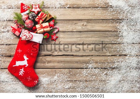 Christmas stocking and toys over rustic wooden background