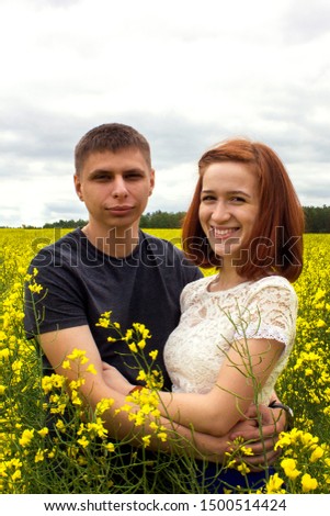 Beautiful couple in a yellow rapeseed field