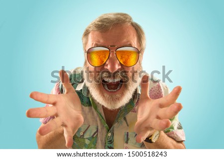 Oktoberfest senior man with sunglasses full of light beer, looking at sea or ocean of alcohol. Facial expression, astonished, crazy happy.The celebration, holidays, festival concept. Bright picture.