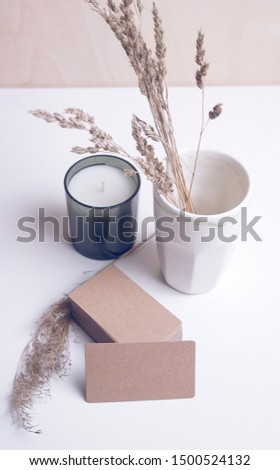 Brown business card mockup with cup and candle. Wedding invitation.