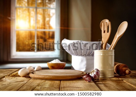 Cook hat on desk and autumn window background 
