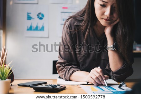Business woman using calculator for do math finance on wooden desk in office and business working background, tax, accounting, statistics and analytic research concept Royalty-Free Stock Photo #1500592778