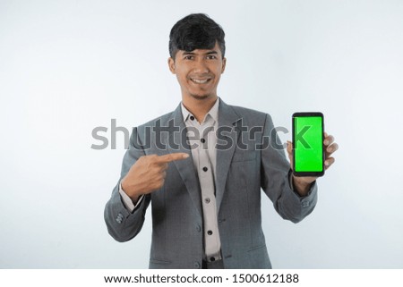 Portrait of Asian Young Business man showing smart cell phone with green screen phone isolated on white background