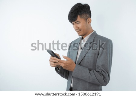 Portrait of asian young business man using smart cell phone isolated on white  background