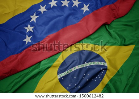 waving colorful flag of brazil and national flag of venezuela. macro