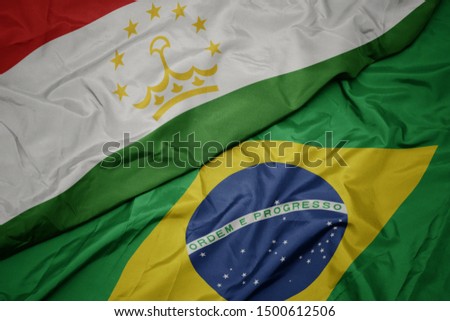 waving colorful flag of brazil and national flag of tajikistan. macro
