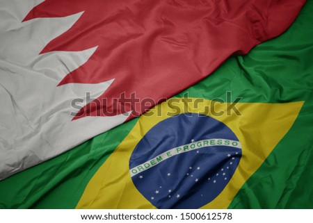 waving colorful flag of brazil and national flag of bahrain. macro