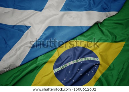 waving colorful flag of brazil and national flag of scotland. macro