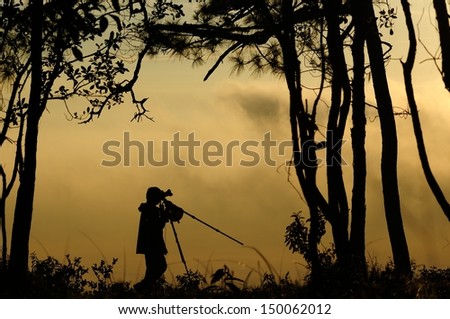 Silhouette photographer in the morning 
